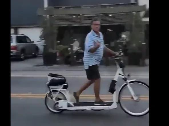 Man walking on the treadmill deck of an electric walking bike